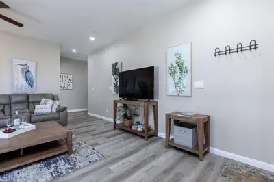 a living room with a couch and a flat screen tv at Luxury, Style and Comfort 4 Bathrooms 21 in Ridgecrest