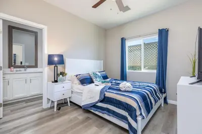 a bedroom with a blue and white bed and a window at Refreshing and Spotless 4 Bathrooms 22 in Ridgecrest