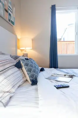 a bed with a book on it with a window at Refreshing and Spotless 4 Bathrooms 22 in Ridgecrest