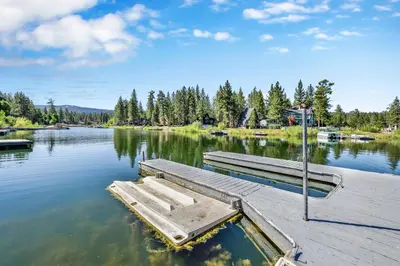 a dock with two benches on a lake at Breezy estate #114 in Big Bear Lake