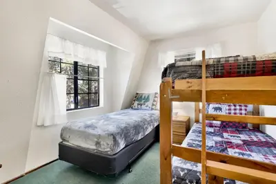 a bedroom with two bunk beds and a window at Breezy estate #114 in Big Bear Lake