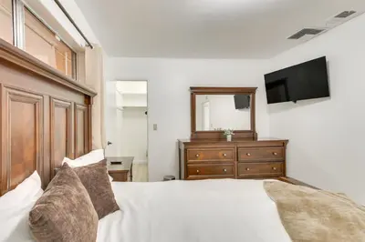 a bedroom with a bed with a mirror and a dresser at Pet-Friendly Ridgecrest Home Near OHV Trails! in Ridgecrest