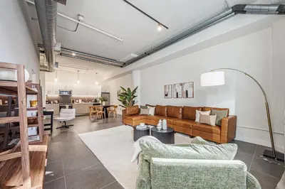 a living room with couches and a dining room at Downtown Escape - 2BR w Skyline Views & Hot Tub in Los Angeles