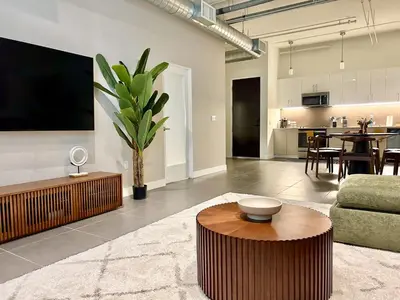 a living room with a couch and a table at Luxury 2BR in DTLA w Jacuzzi & Rooftop Views in Los Angeles