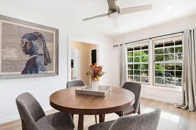 a dining room with a wooden table and chairs at Updated 3-Bedroom LA Home with Backyard, BBQ & Family-Friendly Amenities in Los Angeles