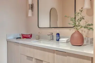 a bathroom with a sink with a vase on it at City Center Hotel By Kasa in Long Beach