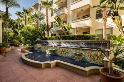 a courtyard with a fountain in front of a building at Lux One Bedroom Condo with Garden View in Los Angeles