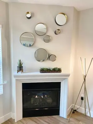 a room with a fireplace with mirrors on the wall at Lux One Bedroom Condo with Garden View in Los Angeles