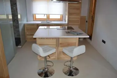 a kitchen with a counter and two stools in it at Hilgard House Westwood Village in Los Angeles