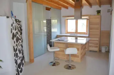 a kitchen with a counter and two stools in a room at Hilgard House Westwood Village in Los Angeles