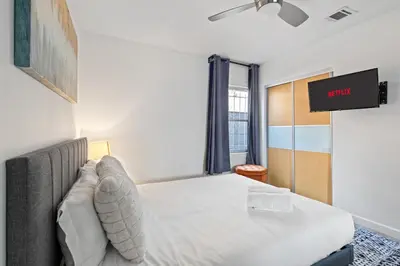 a bedroom with a bed and a flat screen tv at Modern Oasis with Pool & Jacuzzi near Universal Studios in Los Angeles