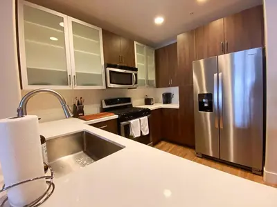 a kitchen with a stainless steel refrigerator at 1 Bedroom XL Condo with King bed, Garden View, Parking Included in Los Angeles