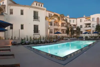 a swimming pool in front of a building at 1 Bedroom XL Condo with King bed, Garden View, Parking Included in Los Angeles