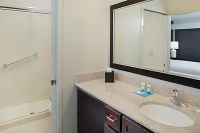 a bathroom with a sink and a mirror at Hyatt House LAX Manhattan Beach in El Segundo