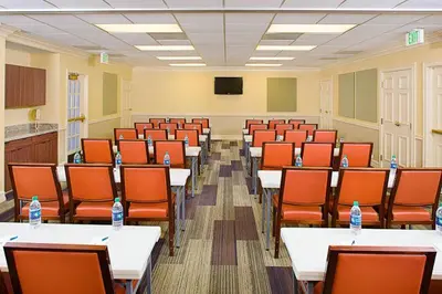 a conference room with tables and chairs and water bottles at Hyatt House LAX Manhattan Beach in El Segundo