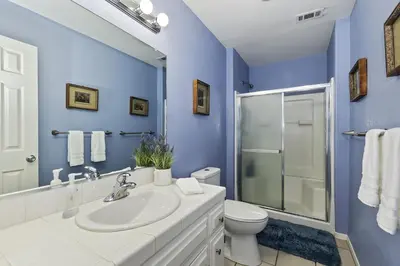 a blue bathroom with a sink and a toilet at Lake Arrowhead Fishermans Haus in Lake Arrowhead