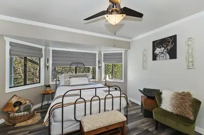 a bedroom with a bed and a ceiling fan at Lake Arrowhead Grass Valley Cabin in Lake Arrowhead