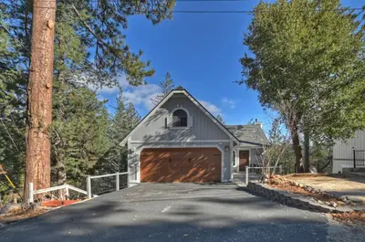 a garage with a large brown garage door at Lake Arrowhead Grass Valley Cabin in Lake Arrowhead