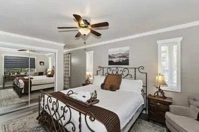 a bedroom with a bed and a ceiling fan at Lake Arrowhead Grass Valley Cabin in Lake Arrowhead
