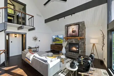 a living room with a fireplace and a couch at North Bay Chalet Views in Lake Arrowhead