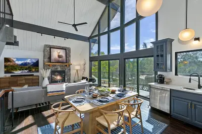 a kitchen and living room with a table and chairs at North Bay Chalet Views in Lake Arrowhead