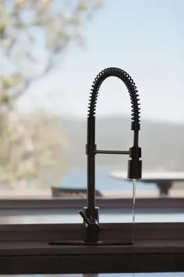 a kitchen sink with a faucet next to a window at Lake Arrowhead Matterhorn Views in Lake Arrowhead