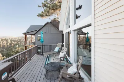 a deck with chairs and a pool on a house at Lake Arrowhead Matterhorn Views in Lake Arrowhead