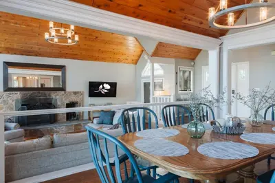 a dining room with a table and chairs and a fireplace at Lake Arrowhead Matterhorn Views in Lake Arrowhead