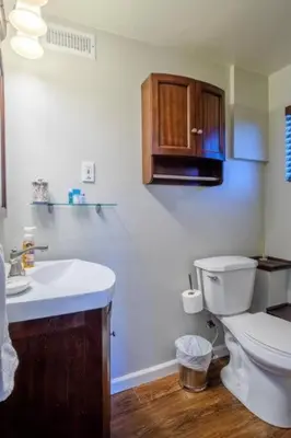 a bathroom with a white toilet and a sink at The Muddy Moose- Spacious Family Getaway in Lake Arrowhead