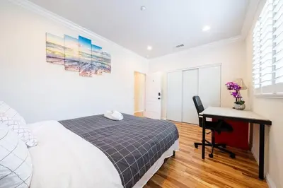 a bedroom with a bed and a desk with a computer at 17-19ppl BTW Dsny Hllywd GarageParking Yard Grill in Monterey Park