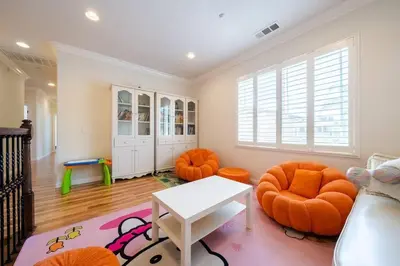 a living room with orange chairs and a table at 17-19ppl BTW Dsny Hllywd GarageParking Yard Grill in Monterey Park