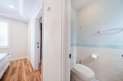 a white bathroom with a toilet and a shower at 17-19ppl BTW Dsny Hllywd GarageParking Yard Grill in Monterey Park