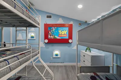 a bedroom with two bunk beds and a tv show on the wall at Pixar Pier by OC Adventure Homes in Anaheim