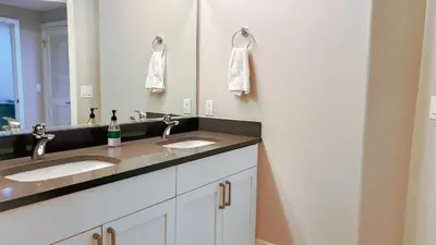 a bathroom with two sinks and a mirror at Modern Apartment in Trendy Area in Los Angeles