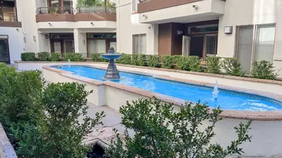 a swimming pool in front of a building at Modern Apartment in Trendy Area in Los Angeles