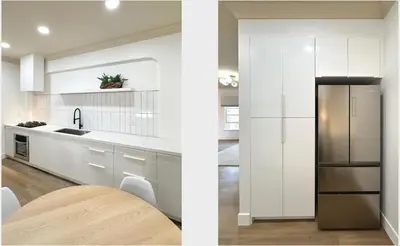 a kitchen with white cabinets and a refrigerator at Broskin apartments in Los Angeles