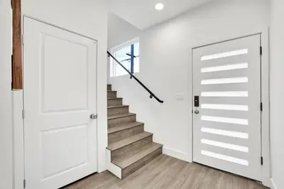 a white door in a hallway with a staircase at Modern Rooftop Villa in Los Angeles