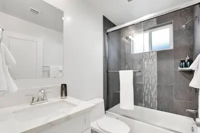 a bathroom with a sink and a toilet and a shower at Modern Rooftop Villa in Los Angeles