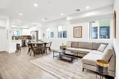 a living room with a couch and a table at Modern Rooftop Villa in Los Angeles