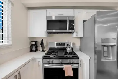 a kitchen with a stove and a microwave at Central Hollywood Apartment in Los Angeles