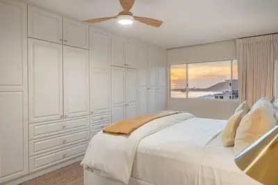 a white bedroom with a bed and a window at Aqualina Best View in Malibu by Stay Awhile Villas in Malibu