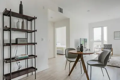 a living room with a table and chairs at Blueground Pasadena gym elev near bars LAX-1231 in Los Angeles