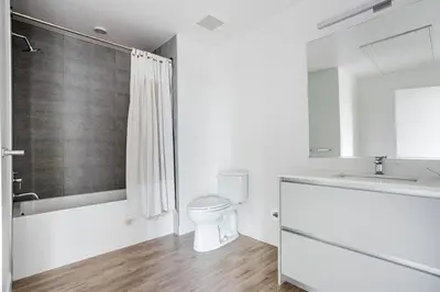 a white bathroom with a toilet and a sink at Blueground Pasadena gym elev near bars LAX-1231 in Los Angeles