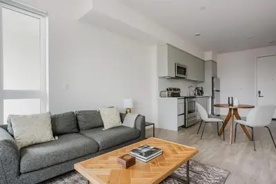 a living room with a couch and a table at Blueground Pasadena gym elev near bars LAX-1231 in Los Angeles