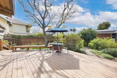 a patio with a table and an umbrella at Classic Home Near Downtown & Hollywood in Los Angeles