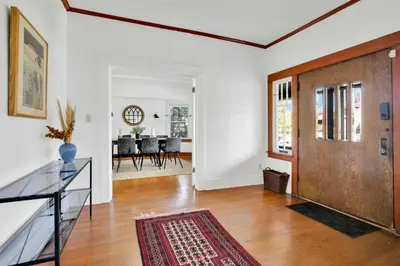 an open living room with a wooden door and a dining room at Classic Home Near Downtown & Hollywood in Los Angeles