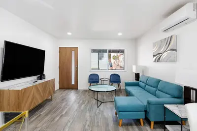 a living room with a couch and a flat screen tv at Cozy House Minutes From Downtown in Los Angeles