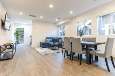 a dining room and living room with a table and chairs at LA Cityscapes in Los Angeles