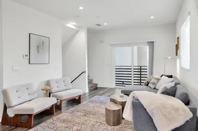 a living room with a couch and a chair at Luxe Townhouse Near Downtown LA in Los Angeles