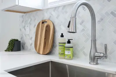 a kitchen counter with a sink and a cutting board at Spectacular Rooftop View House in Los Angeles